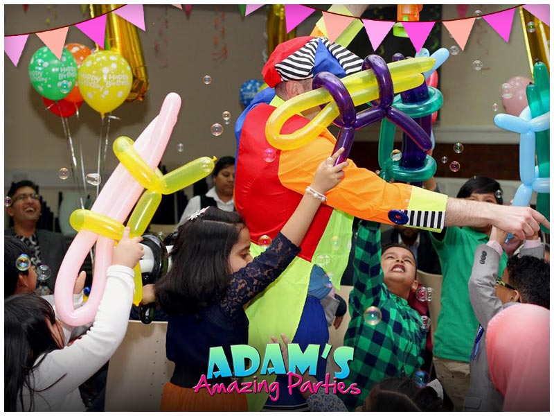 Adam with balloons, kids chasing and bubbles